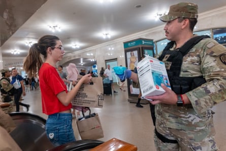 National Guard soldiers hand out face masks to commuters at Grand Central Terminal as haze from Canadian wildfires blankets Manhattan in New York City.Photograph: Spencer Platt/Getty Images