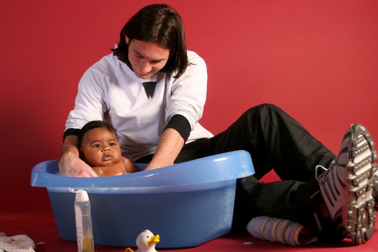 20-year-old soccer star Lionel Messi helps to bathe Lamine Yamal, who was merely six months old at the time, during a photo session in Sept. 2007 in the dressing room of the Camp Nou stadium in Barcelona.Joan Monfort / AP file