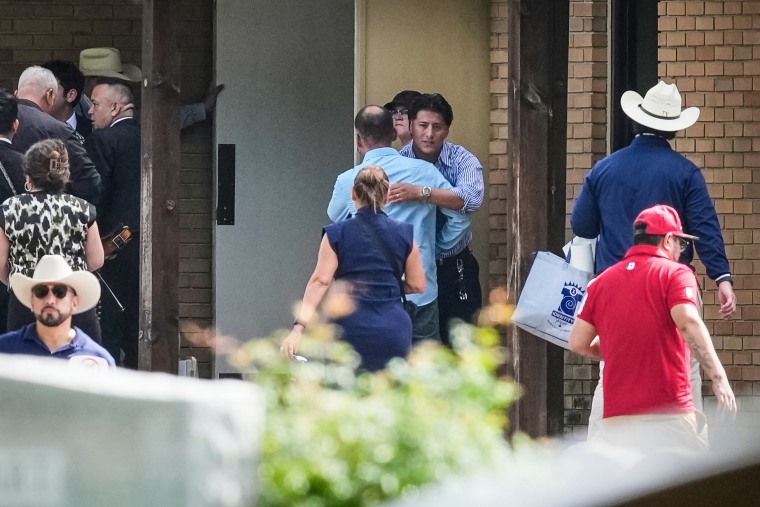 Ronaldo Salgado, son of Lorenzo Salgado Araujo, who was shot and killed by an ICE officer last week, is hugged outside a public visitation for this father on Thursday in Houston.David J. Phillip / AP