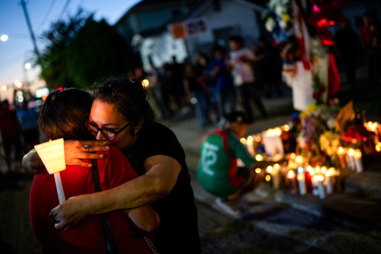 People embrace as they pay their respects to Lorenzo Salgado Araujo during a candlelight vigil on July 8 in Houston, Texas.Brandon Bell / Getty Images