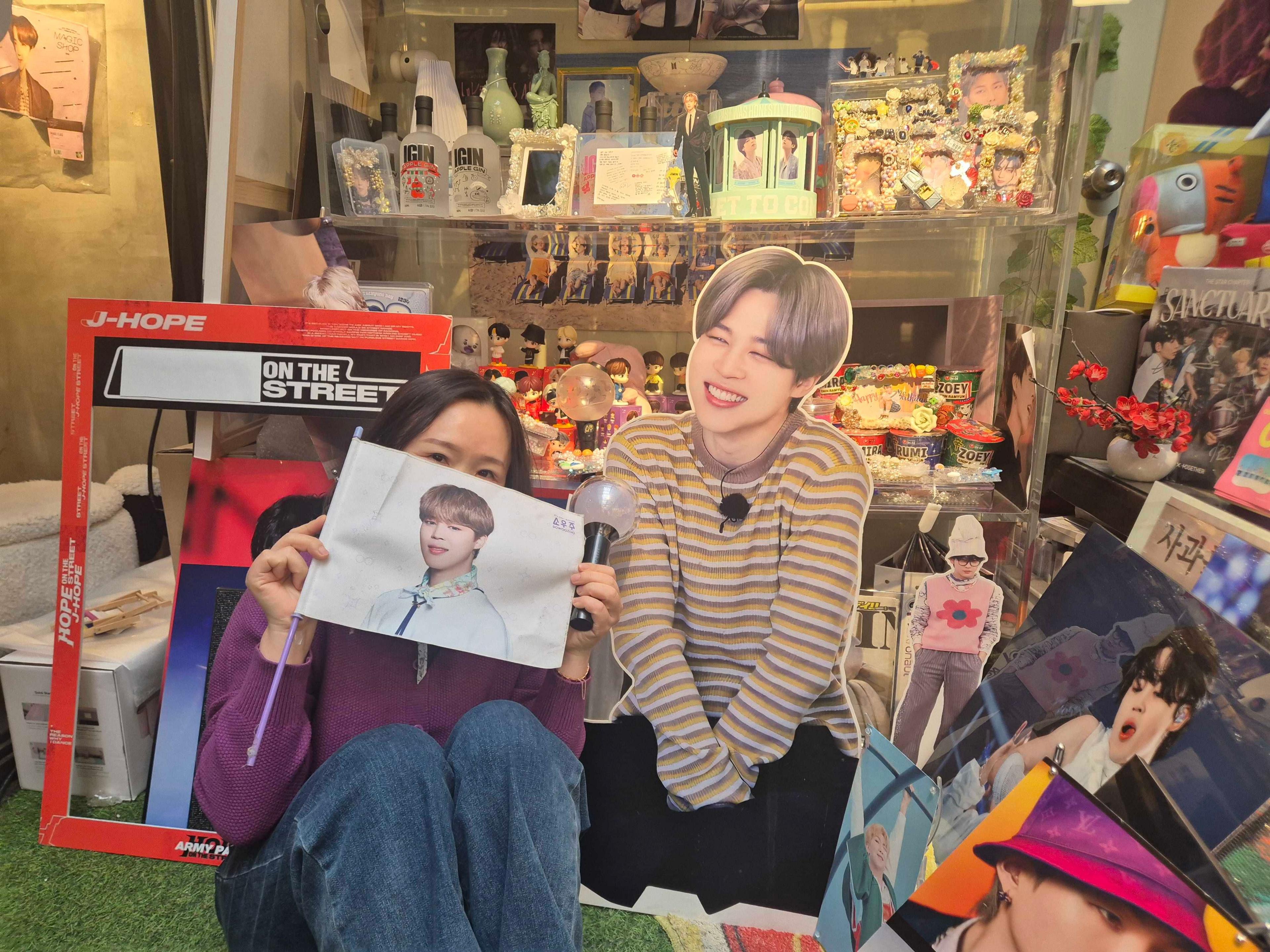 Image caption,Yeon-su, pictured here at a BTS-themed café in Seoul, had not heard South Korean music before leaving her country