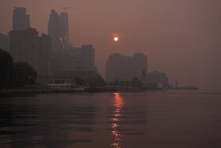 The sun rises over Toronto’s waterfront through dense wildfire smoke as poor air quality persists across the city on Thursday.Photograph: NurPhoto/Getty Images