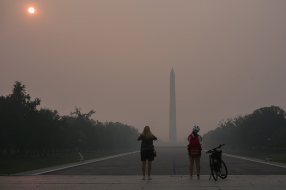 Wildfire smoke shrouds the sun as it rises behind the skyline of midtown Manhattan on Friday.Gary Hershorn / Getty Images