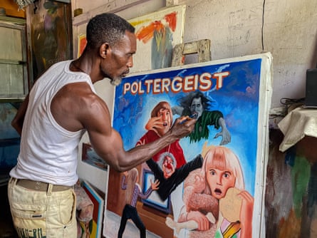 Benjamin Amartey, popularly known as Stoger, creates a poster for the film Poltergeist in his studio in Ashaiman, Ghana.Photograph: Carlos Mureithi/The Guardian