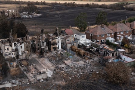 Homes in Wennington, Greater London, were gutted by fire during the UK’s extreme heatwave in July 2022.Photograph: Dan Kitwood/Getty Images