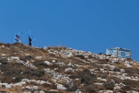 Israeli settlers work on Friday to build a new outpost at the Palestinian village of Azmut in the occupied West Bank.Photograph: Jaafar Ashtiyeh/AFP/Getty Images