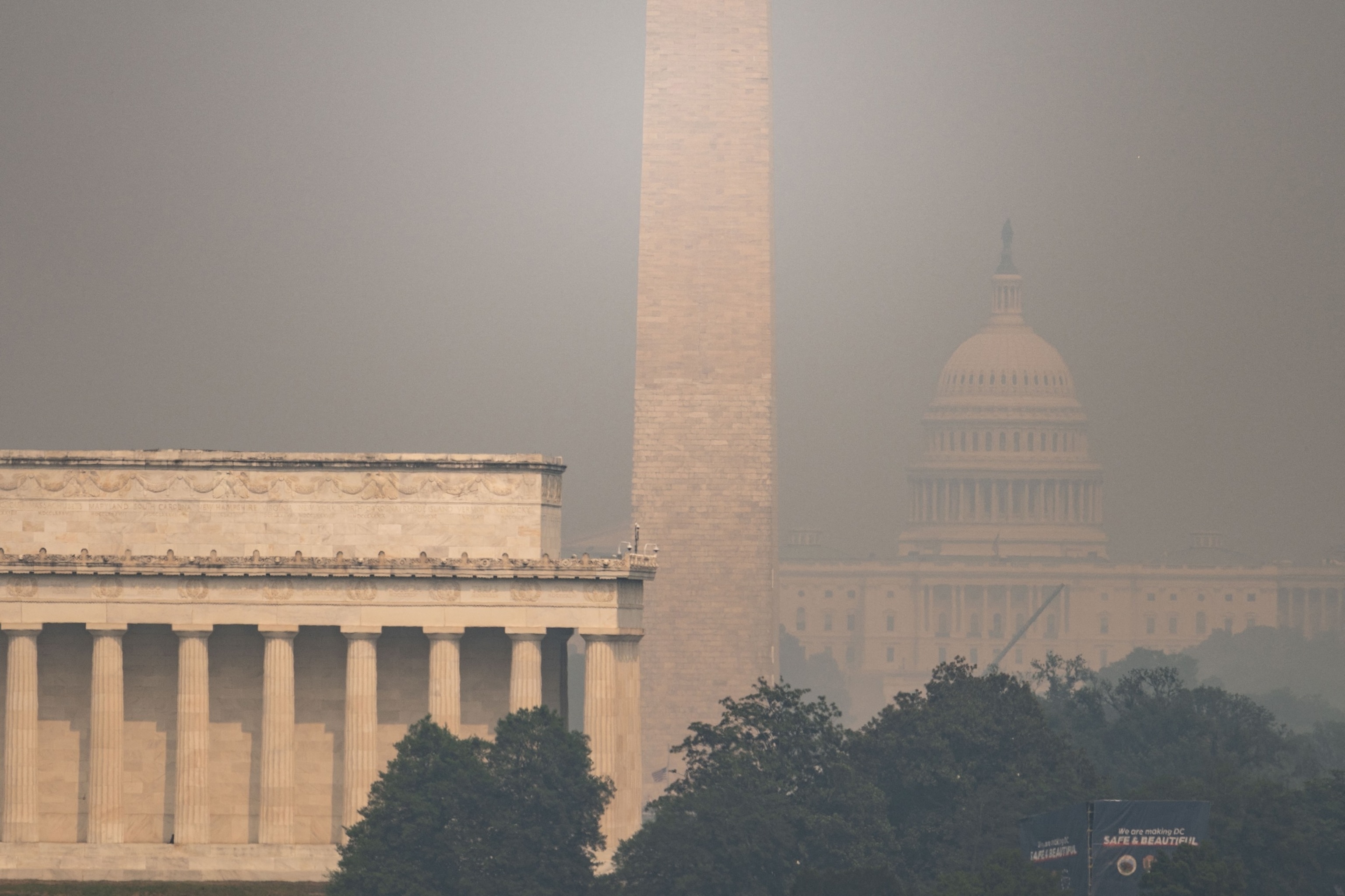 The US Capitol, Washington Monument and Lincoln Memorial are seen through haze caused by wildfire smoke from Canada from the Netherlands Carillon in Arlington, Virginia on July 17, 2026. Dense smoke from wildfires burning in Canada obscured the skyline of the National Mall on July 17, as President Trump criticized Canada's handling of the fires and floated tariffs against the country in response.Kent Nishimura/AFP via Getty Images