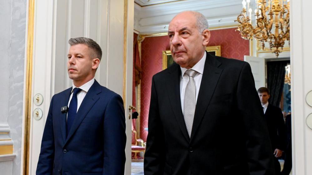 Image caption,Since his party swept to power in April, Péter Magyar (left) has repeatedly called on Sulyok (right) to resign