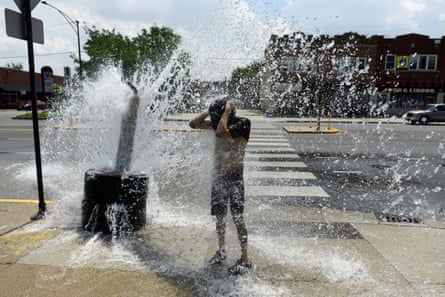 A person cools off with water from an open fire hydrant during a heatwave in Chicago.Photograph: Octavio Jones/AFP/Getty Images