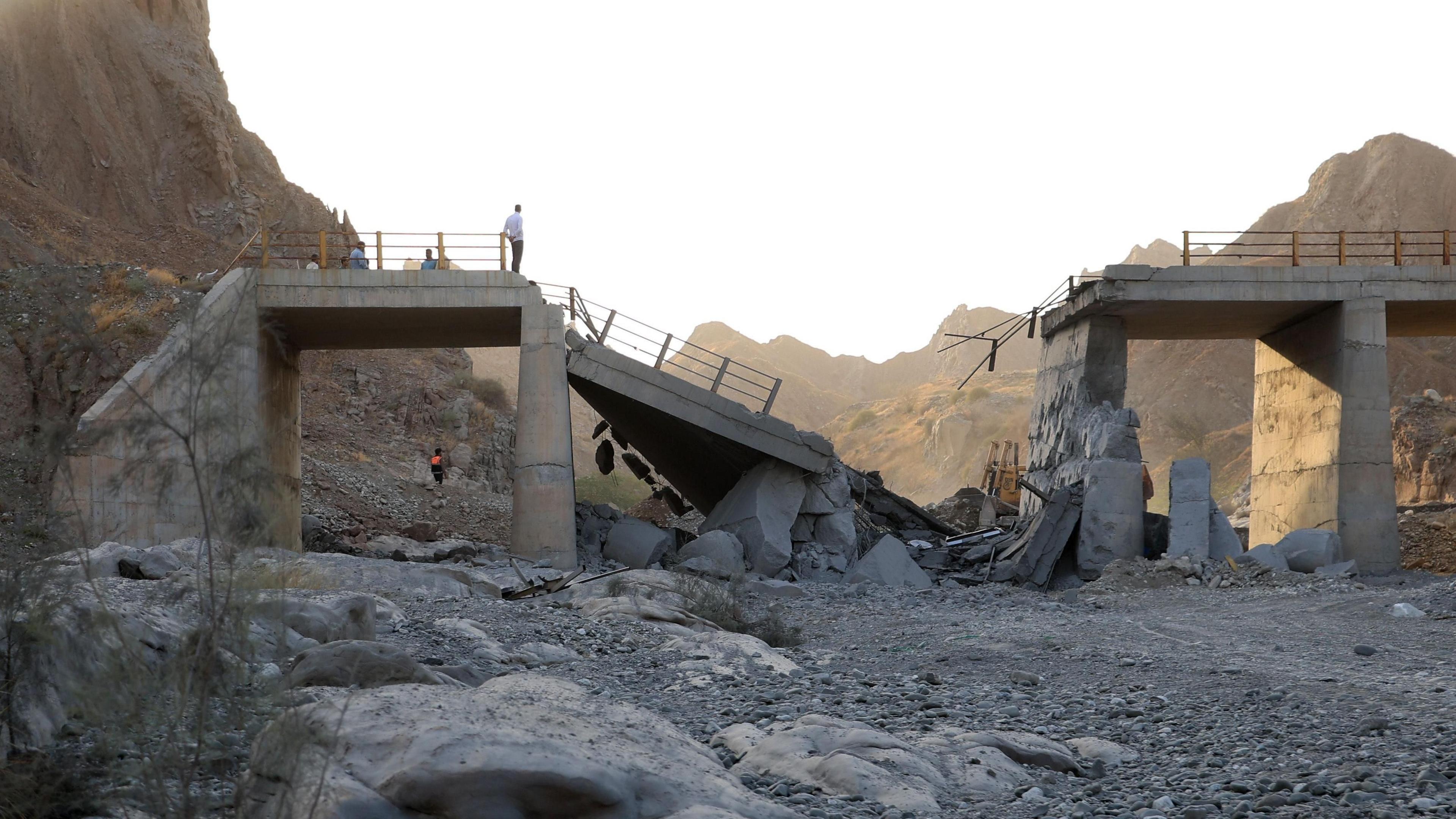 Image caption,Officials inspect a bridge damaged by a US strike in southern Iran on Saturday