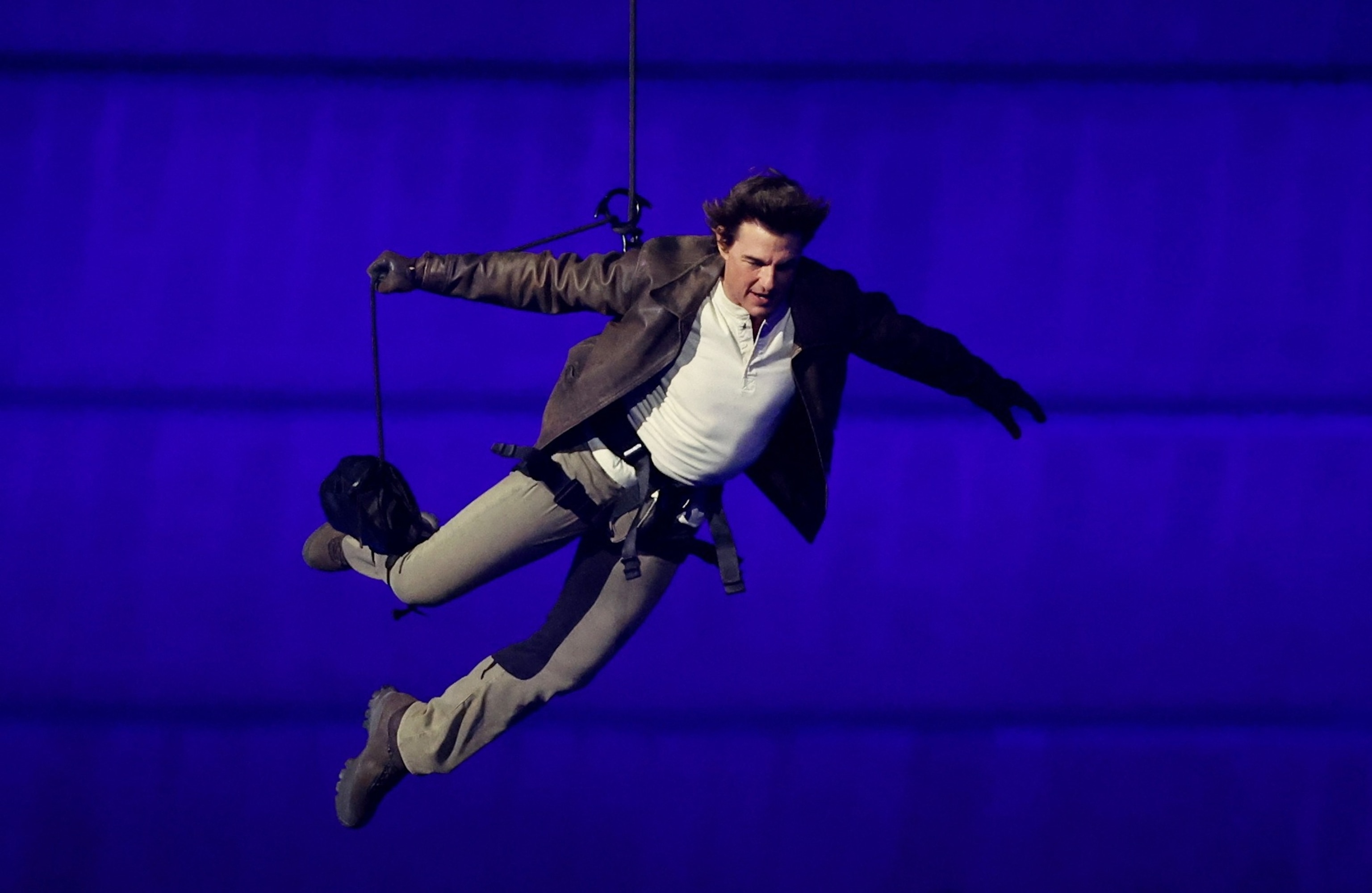 Actor Tom Cruise is lowered from the roof of the Stade de France during the Closing Ceremony of the 2024 Paris Olympic Games, August 11, 2024.Pool/Getty Images