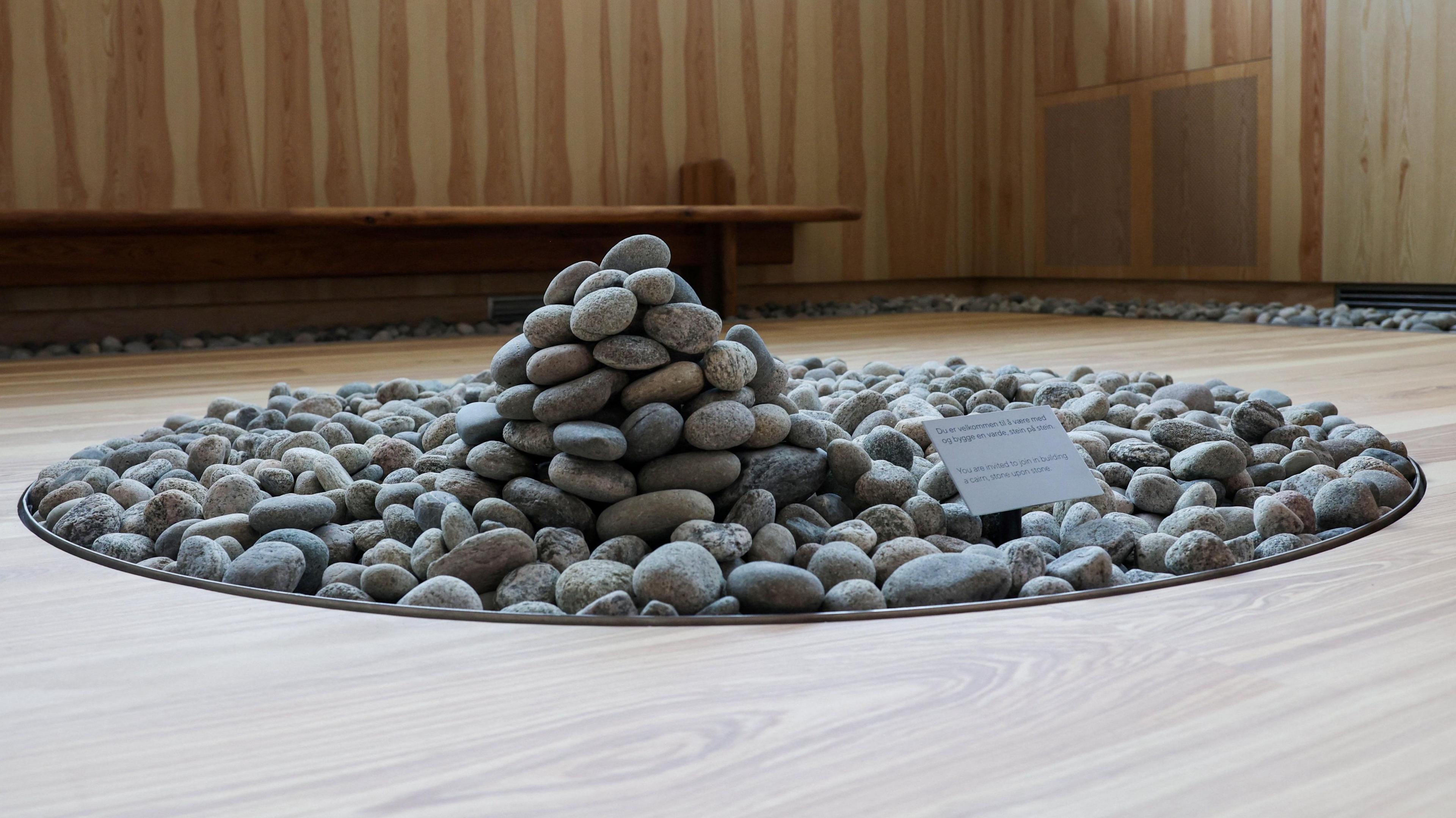 Image caption,A pile of pebbles forms part of the new Oslo memorial for the 2011 massacre victims