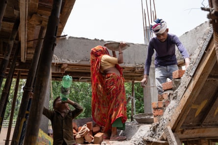 Satyam Kumar, 5, the son of Inder Kumar and Laxmi, drinks water at a construction site in Sector 92, Gurgaon. He doesn’t go to school and stays at the site while his parents work as labourers.Photograph: Smita Sharma/The Guardian