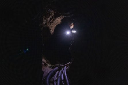 Nilton Tubino walks through a tunnel.Photograph: João Laet/The Guardian