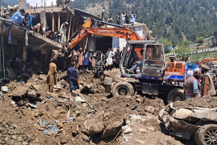 Residents and rescue workers clear debris in Parun, Nuristan province.Photograph: EPA