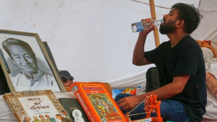 Abhijeet Dipke, founder of the Cockroach Janta party, next to a portrait of hunger-striking activist Sonam Wangchuk during a protest in Delhi on Tuesday.Photograph: Shekhar Yadav/AP