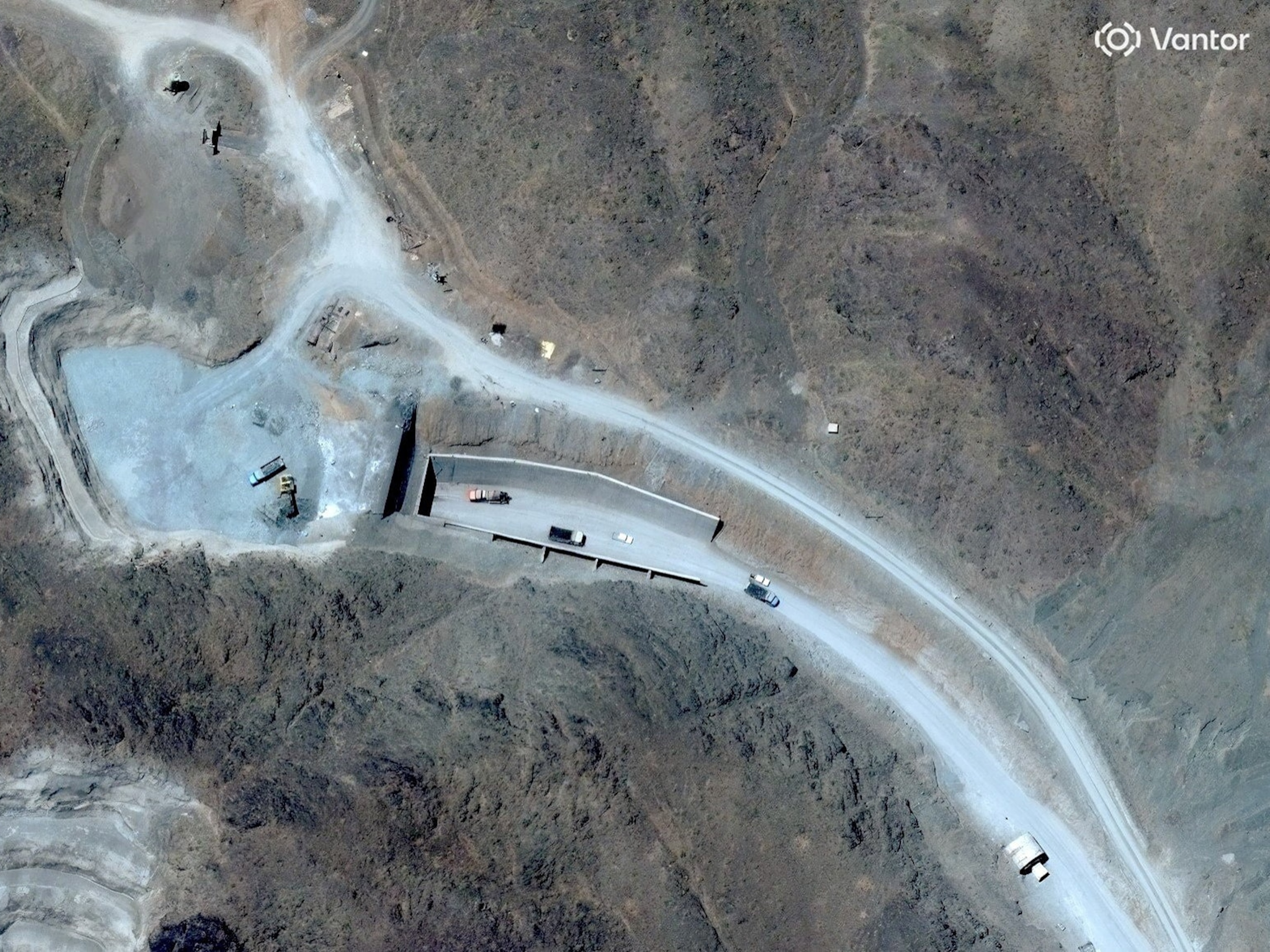 A satellite view shows vehicles at an entrance to Pickaxe Mountain tunnels, of the of the Natanz nuclear facility, near Natanz, Iran, June 21, 2026.Vantor via Reuters