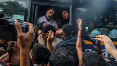 Rahul Gandhi detained and pulled on to bus after calling for PM Modi to resign – video