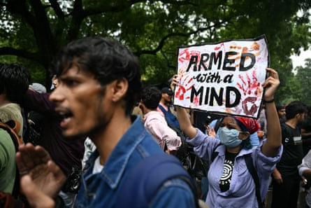 A Cockroach Janta party supporter holding a placard at a protest in Delhi on Wednesday.Photograph: Sajjad Hussain/AFP/Getty