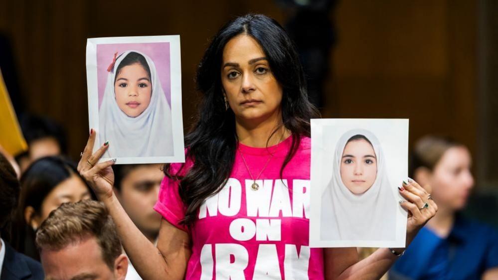 Image caption,Protesters briefly disrupted the hearing