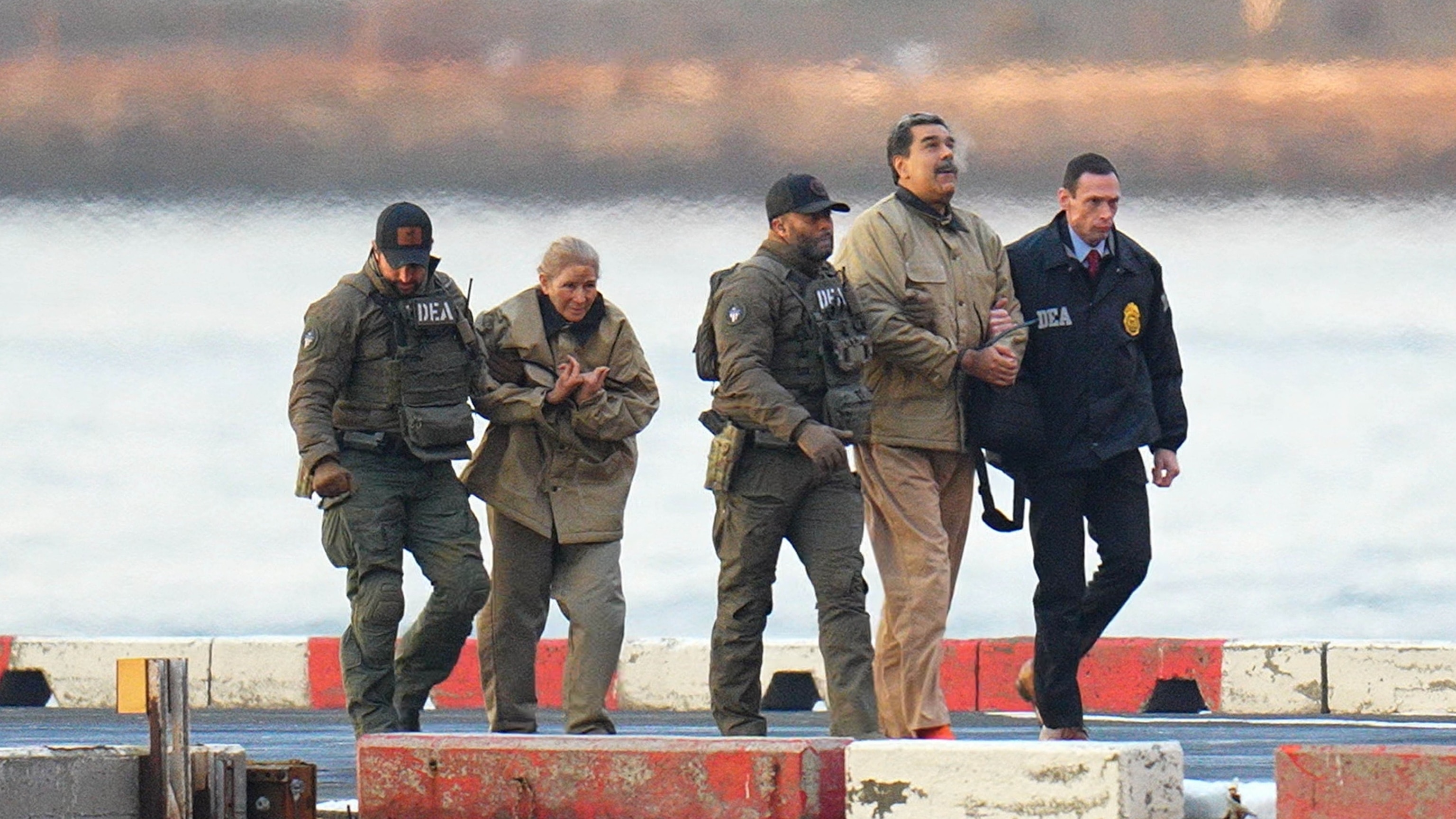 Nicolas Maduro and his wife, Cilia Flores, are seen in handcuffs after landing at a Manhattan helipad, escorted by heavily armed Federal agents as they make their way into an armored car en route to a Federal courthouse in Manhattan on January 5, 2026 in New York City.Xny/star Max/GC Images