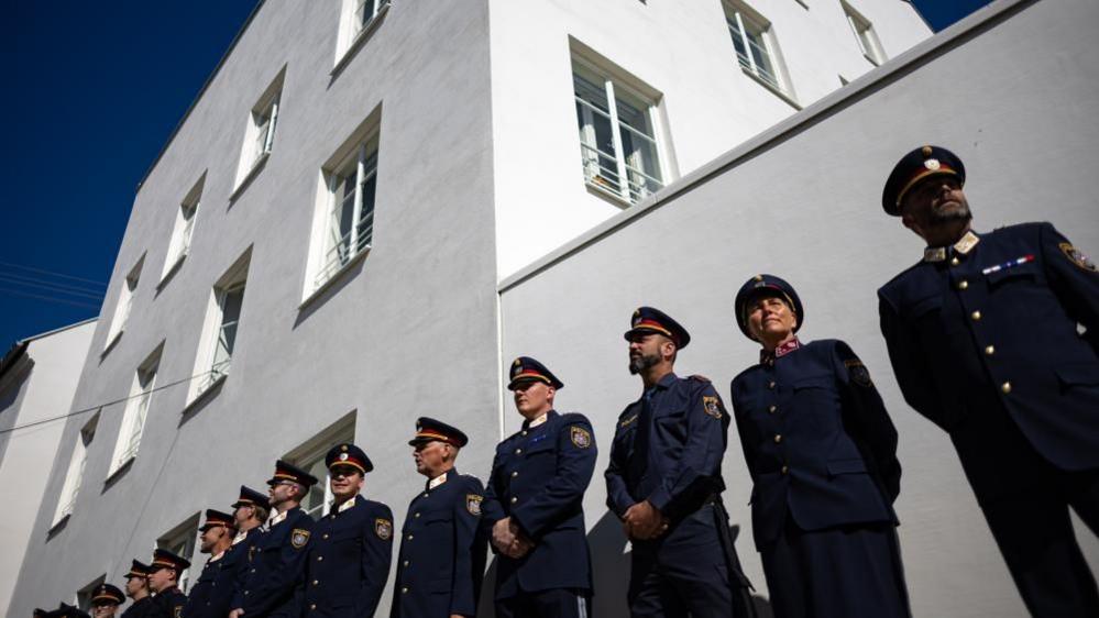 Image caption,Police officers lined up outside the new police station after its opening
