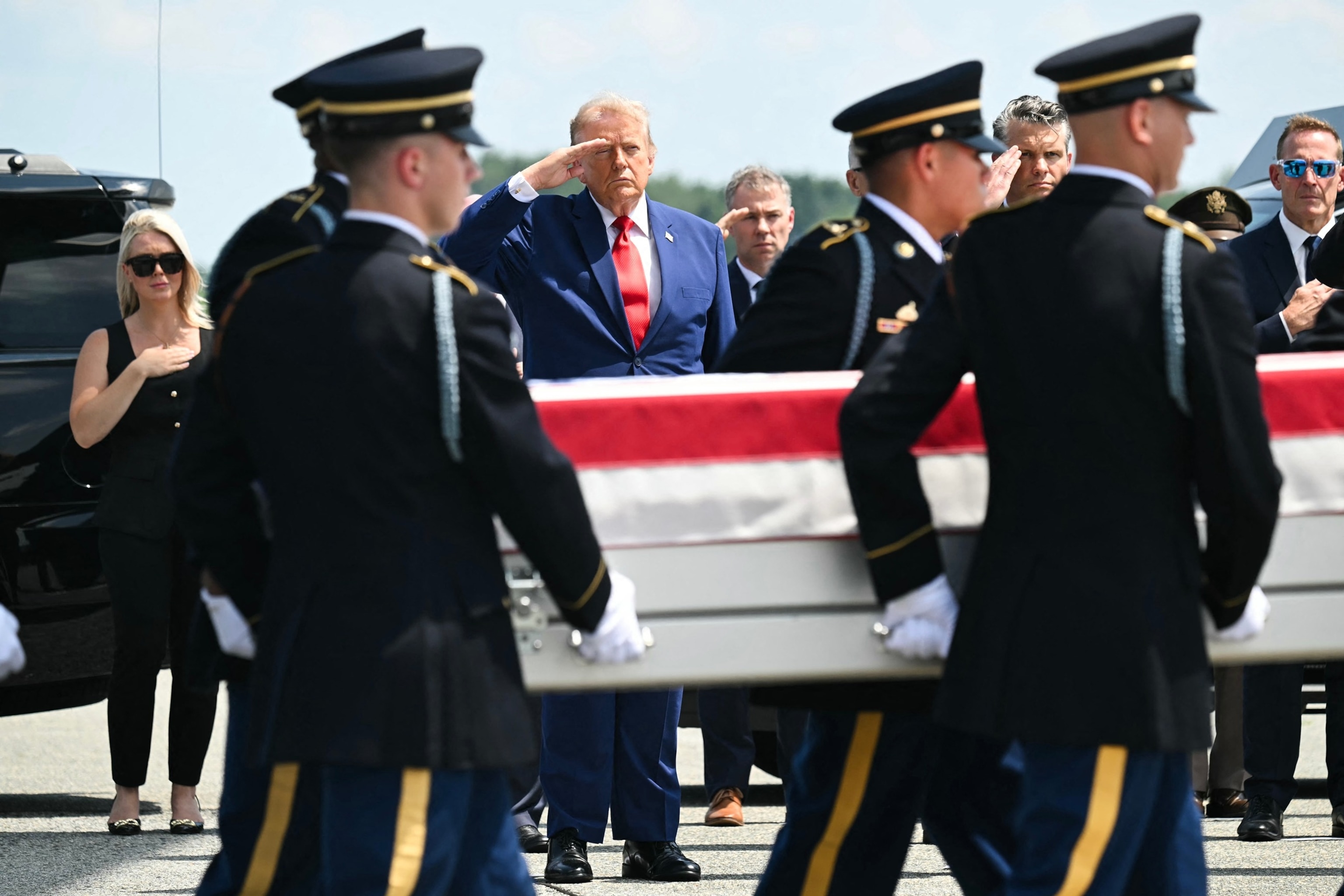President Donald Trump salutes as a US Army carry team carries the flag-draped transfer case containing the remains of 1st Lt. Tyler James Feehan, during a dignified transfer at Dover Air Force Base in Dover, Delaware, July 22, 2026.Saul Loeb/AFP via Getty Images