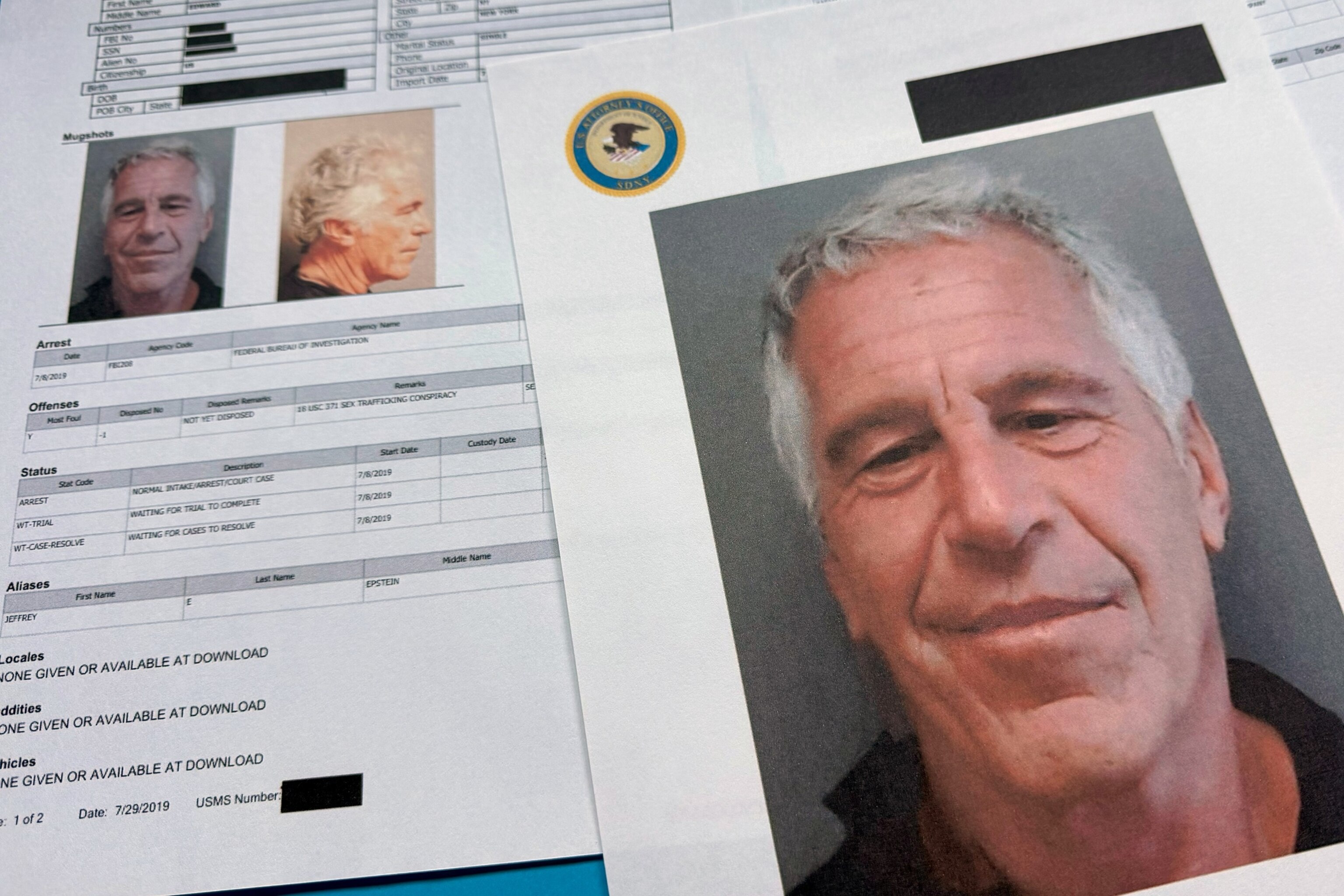 FILE - Documents that were included in the U.S. Department of Justice release of the Jeffrey Epstein files are photographed Friday, Jan. 2, 2026.Jon Elswick/AP, FILE
