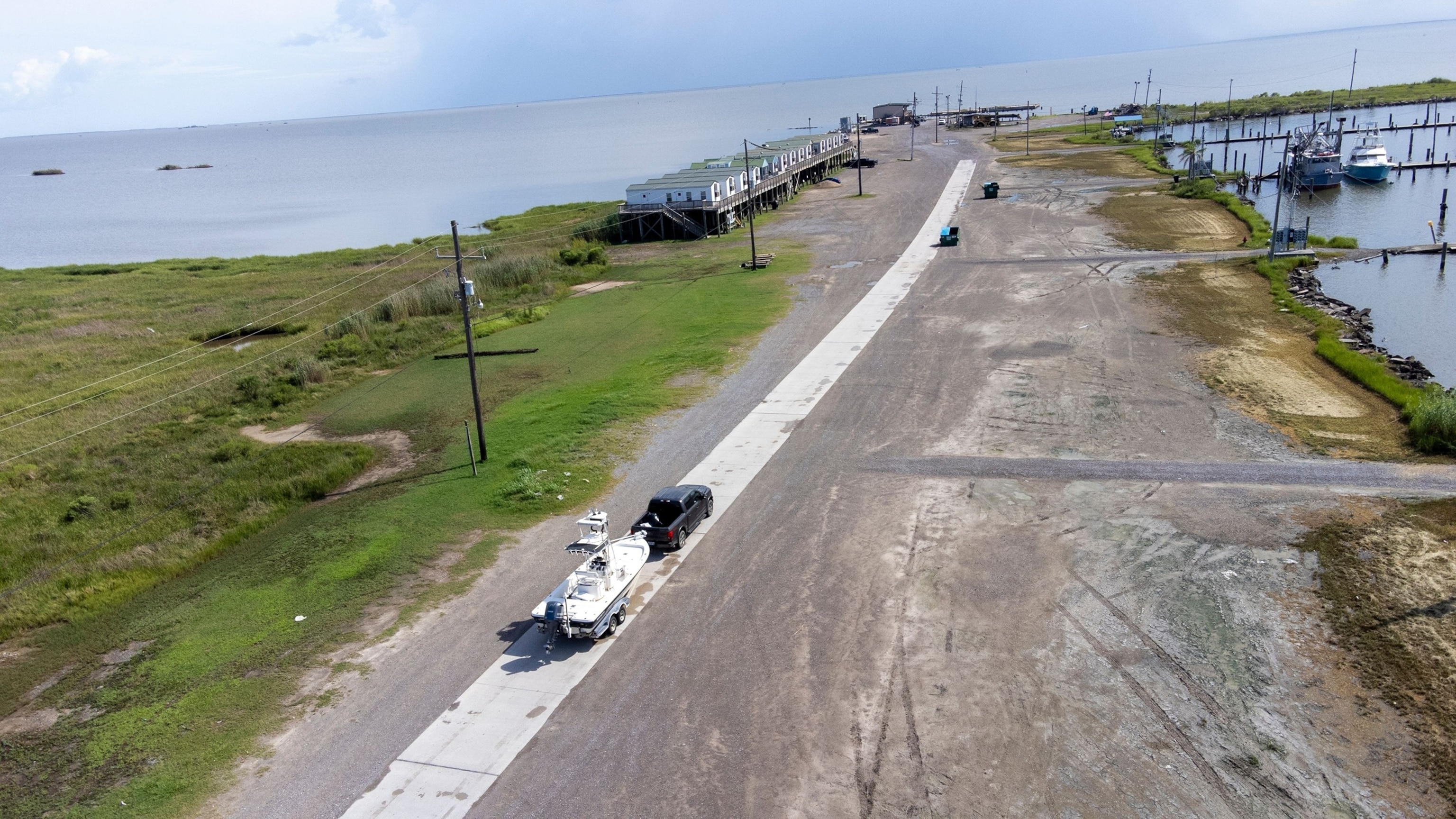 A truck pulls a boat on a trailer at Joshua's Marina set outside the the levee protection and storm surge area in Buras, Louisiana, July 21, 2026.Derick Hingle/EPA/Shutterstock