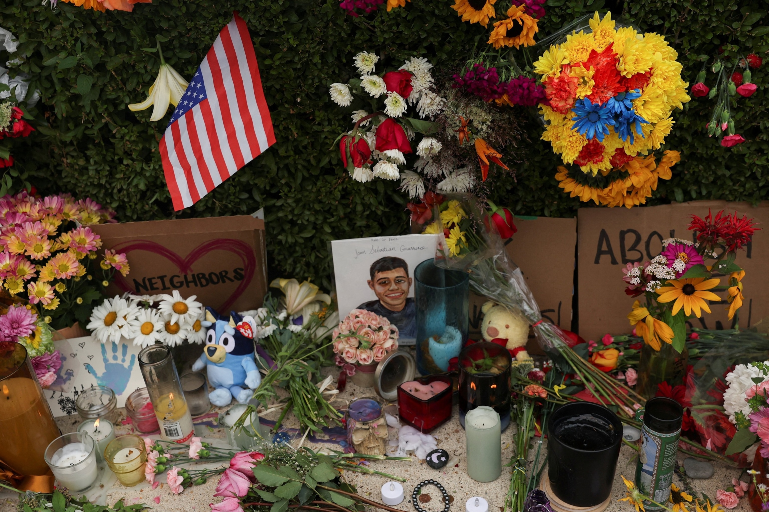 Flowers and a portrait with writing that reads "Joan Sebastian Guerrero" sit at a makeshift street-side memorial, a day after Immigration and Customs Enforcement (ICE) agents fatally shot Guerrero, in Biddeford, Maine, July 14, 2026.Shannon Stapleton/Reuters