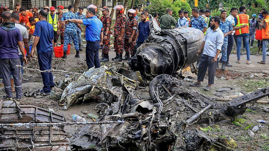 Image caption,Images from the scene hours after the crash showed scores of emergency service workers sorting through charred rubble