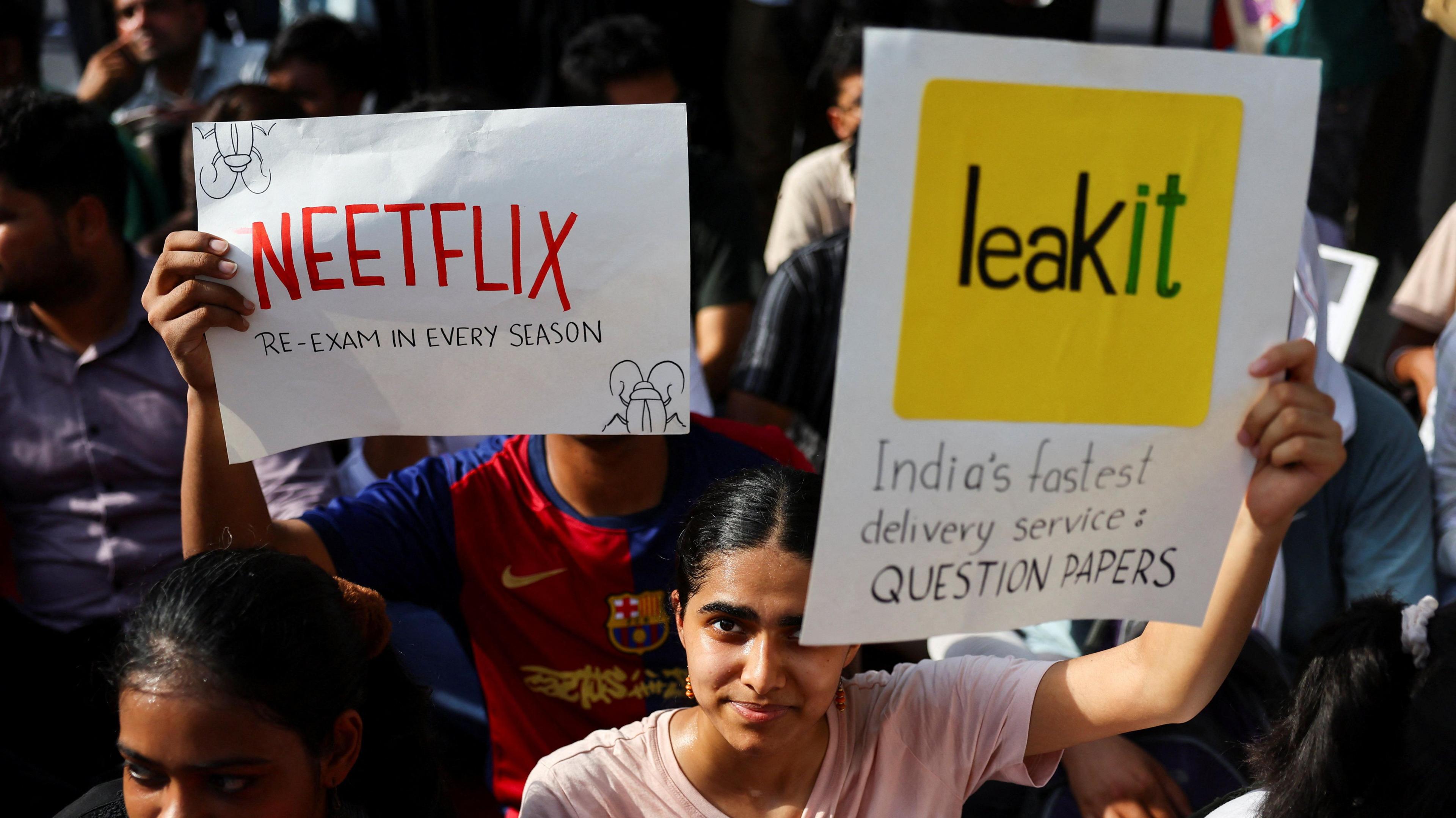 Image caption,From one-liners to satirical digs, the placards have become one of the defining features of the protests