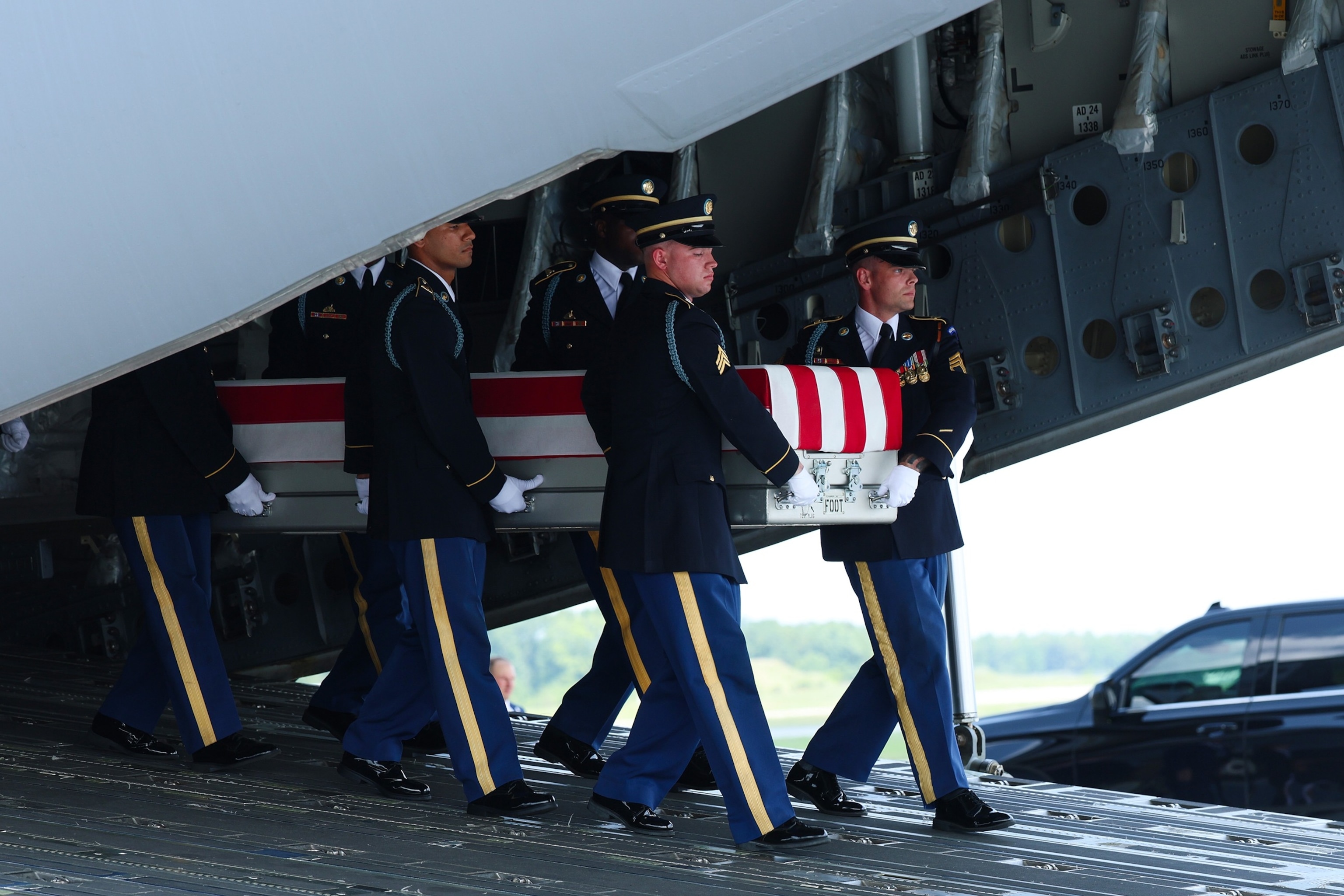 Members of a U.S. Army carry team move the flag-draped transfer case holding the remains of Army Staff Sgt. Michael Emmanuel Swinton of Fayetteville, North Carolina, during a dignified transfer at Dover Air Force Base July 22, 2026 in Dover, Delaware.Kevin Dietsch/Getty Images