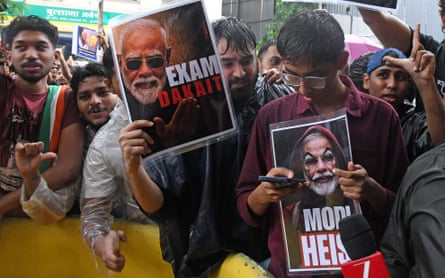 Demonstrators hold anti-Modi placards during a protest.Photograph: Ashish Vaishnav/SOPA Images/Shutterstock