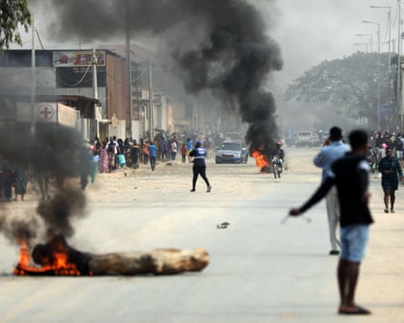 Wood is burned on the street near where people vandalised stores during the first day of the taxi strike in Luanda, Angola, in July 2025.Photograph: Ampe Rogerio/EPA