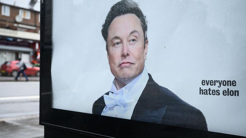 Image caption,An activist group recently hijacked advertisement displays in London to criticise Musk's trillionaire status