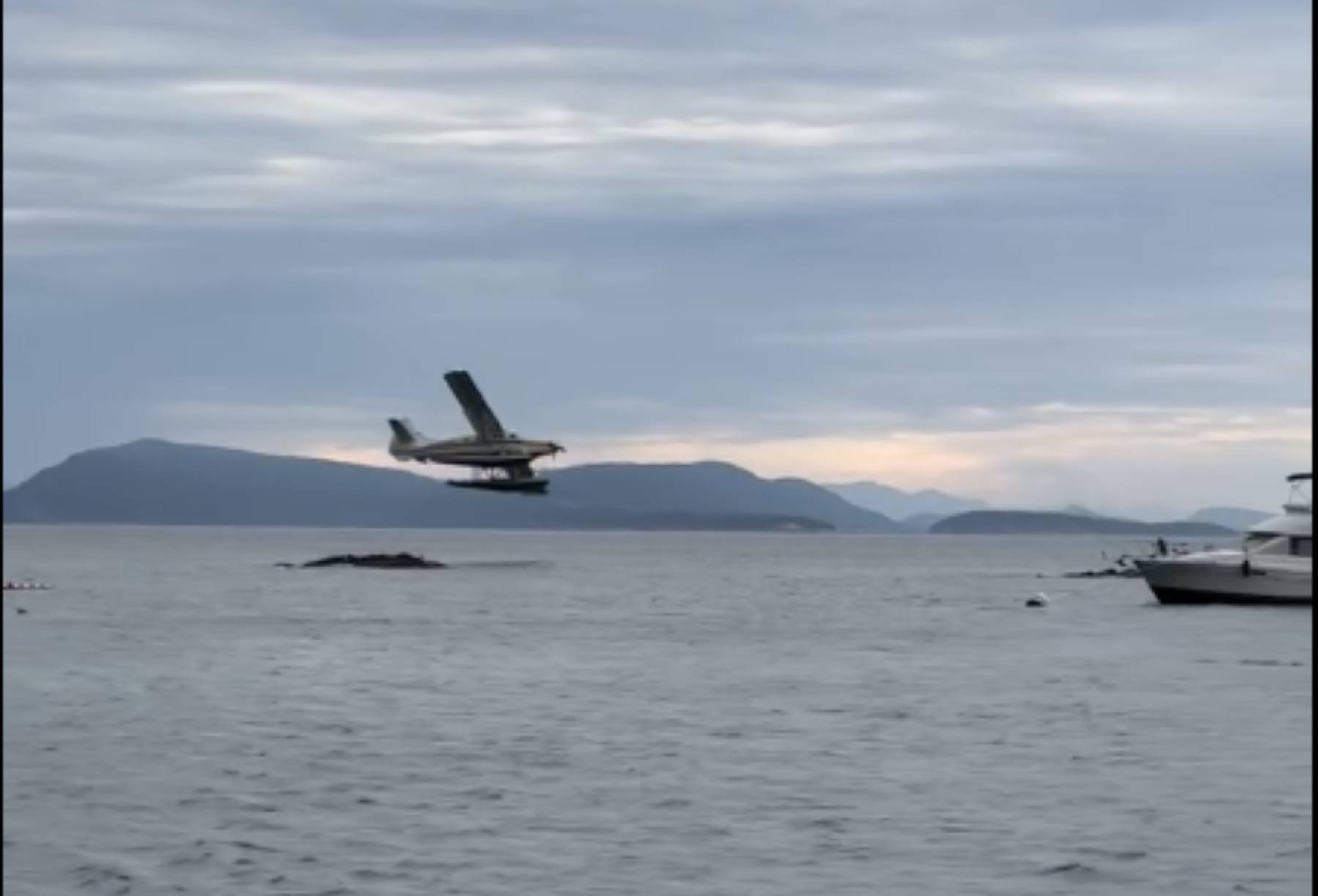 A still photo from a video posted to Facebook shows a Kenmore Air plane that caught fire after crashing off the coast of Washington state.Monica Scott / Facebook