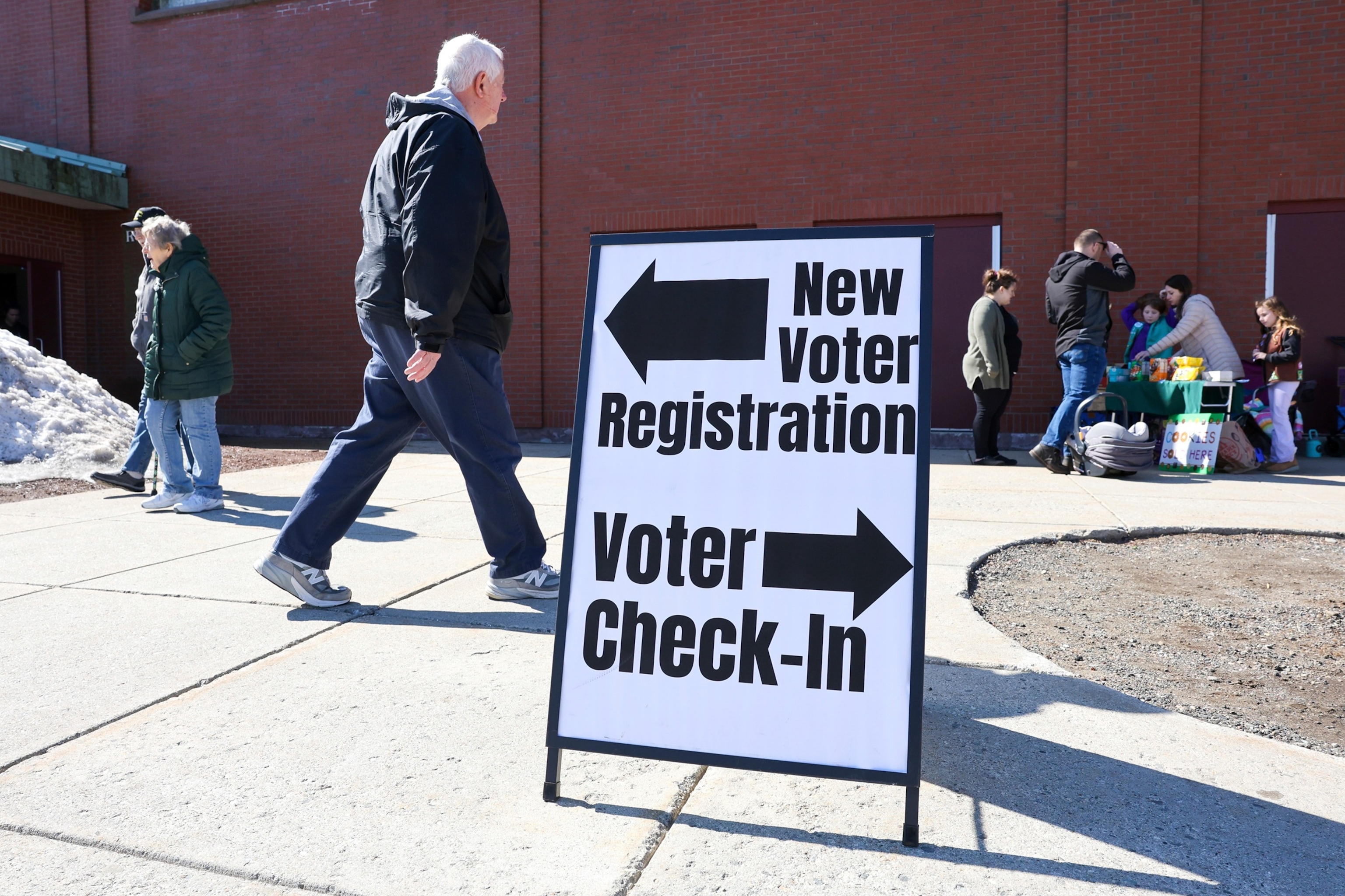A sign for new voter registration is seen outside a polling location at Pinkerton Academy in Derry, N.H., March 11, 2025.Reba Saldanha/AP