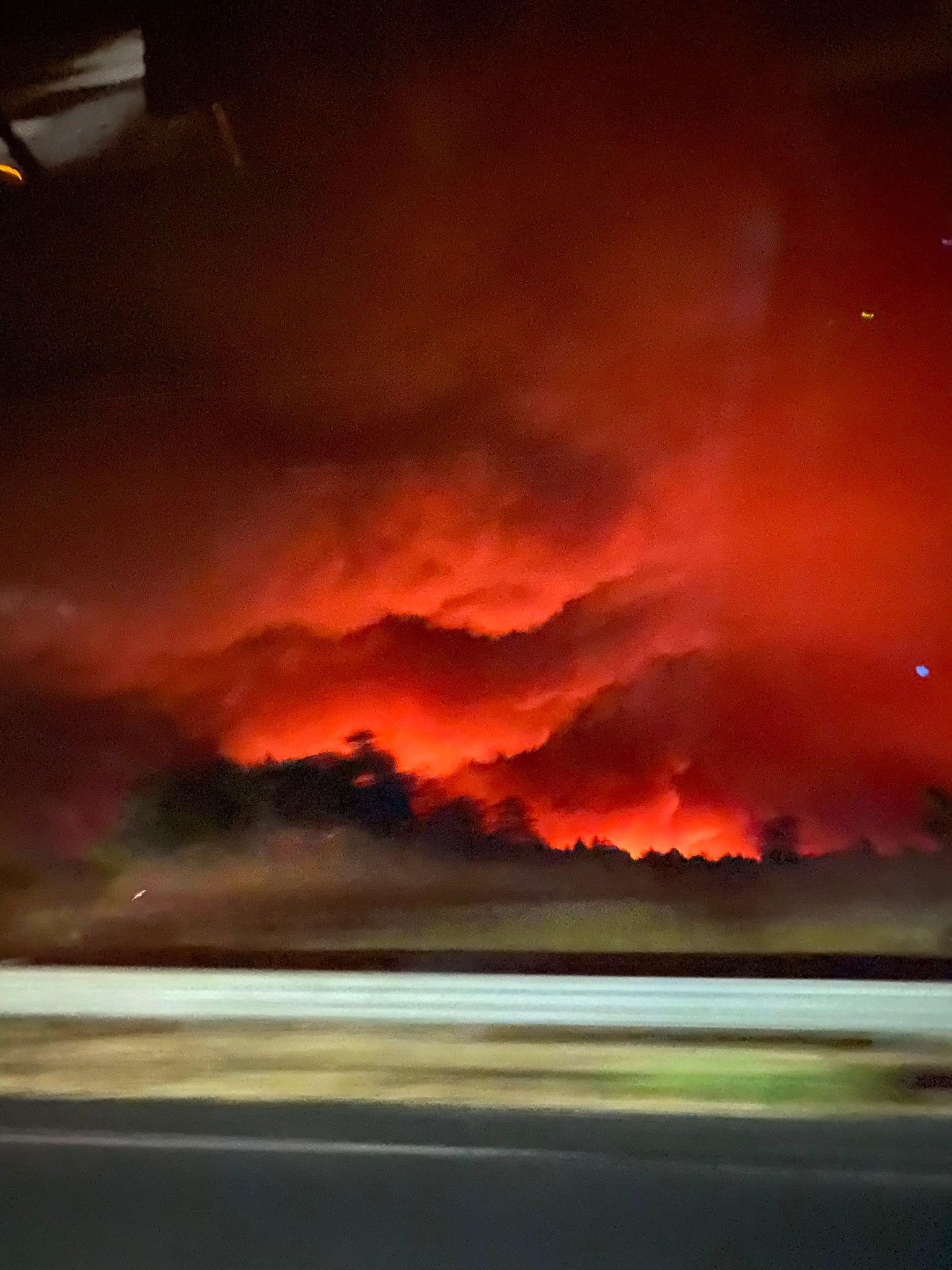 Image caption,Olivia Jarratt took photos from the window of her car as the family evacuated their campsite