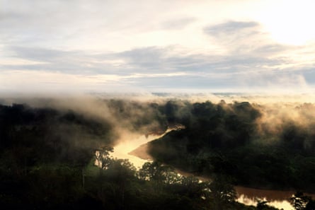 Sunrise on the Amônia River, which runs through the Kampa do Rio Amônia Indigenous territory in Brazil.Photograph: Nicoló Lanfranchi/The Guardian