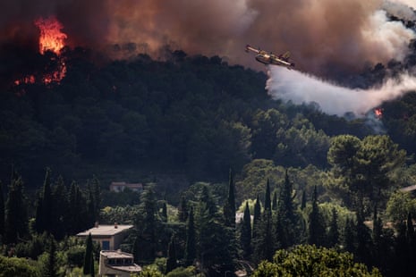 A French Civil Security Canadair CL-415 aircraft sprays water on a forest surrounding Cotignac, southeastern France.Photograph: Thibaud Moritz/AFP/Getty Images