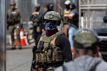 Federal agents stand guard at Delaney Hall, an immigration detention facility, in Newark, New Jersey, in May.Photograph: Julius Constantine Motal/The Guardian