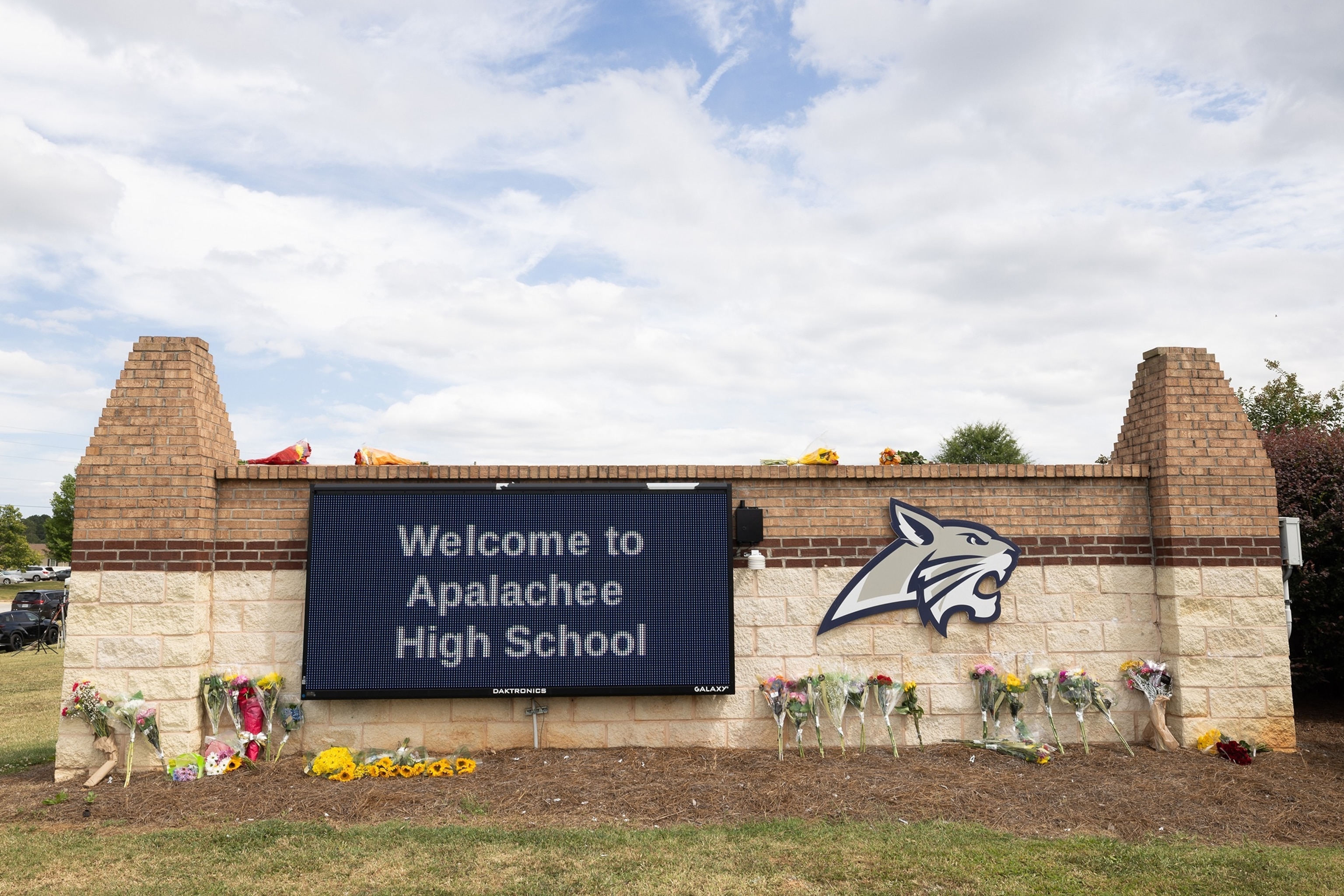 The entrance sign of Apalachee High School adorned with flowers from visitors on September 5, 2024 in Winder, Georgia.Jessica Mcgowan/Getty Images