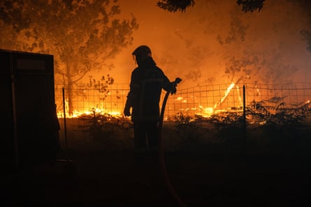 A firefighter battles a wildfire spreading in Lège-Cap-Ferret in the Gironde.Photograph: SDIS33/Damien Rembert/EPA