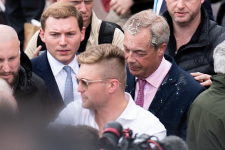 George Cottrell beside Farage on the campaign trail in 2024, when the Reform leader was doused in milkshake.Photograph: James Manning/PA