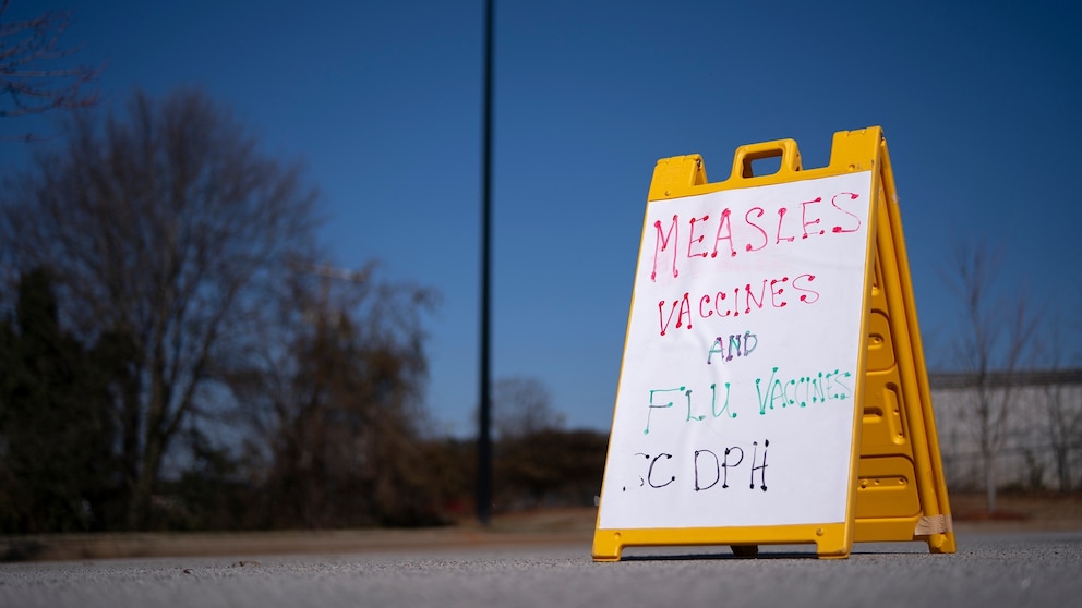 In this Feb. 6, 2026, file photo, a sign is shown outside a mobile clinic offering measles and flu vaccinations in Spartanburg, South Carolina.Sean Rayford/Getty Images, FILE