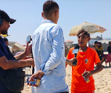 Kamal Taha, 12, being interviewed by a local TV channel