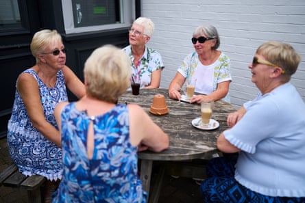 A group sat chatting outside the Cherry Tree in Culcheth, including Richard Partington’s former teacher Mrs Crinion (second from right).Photograph: Christopher Thomond/The Guardian