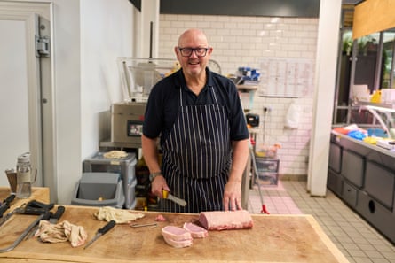 Butcher John Cross at Warrington market.Photograph: Christopher Thomond/The Guardian