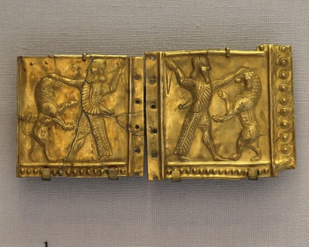 Gold plate showing a character fighting a lion from the Ziwiye Hoard exhibited at the Louvre Museum in Paris.Photograph: Lanmas/Alamy